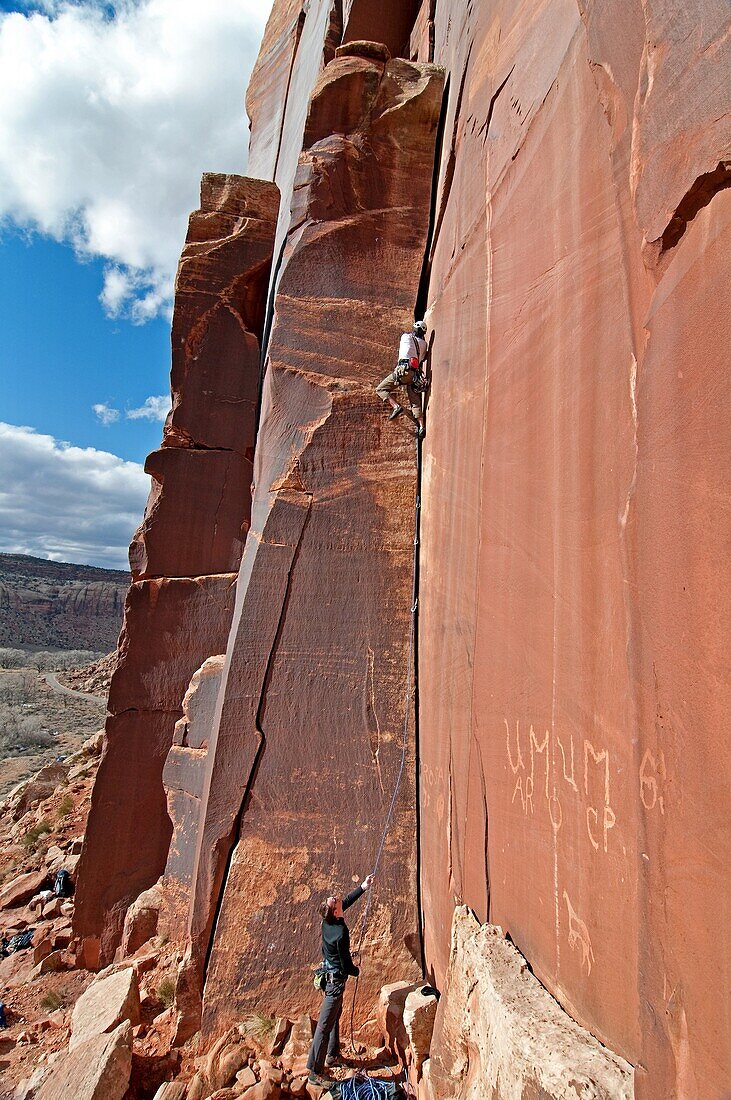 Andrew Stone rock climbing a route called Amaretto Corner on Super Crack Buttress at Indian Creek Canyon in southern Utah