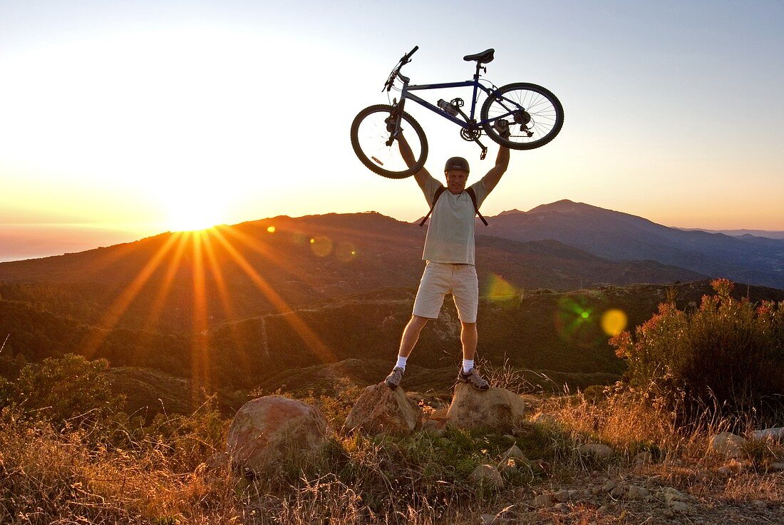 Mark Weber mountain biking at sunset in the Santa Ynez Mountains near the city of Santa Barbara in southern California USA