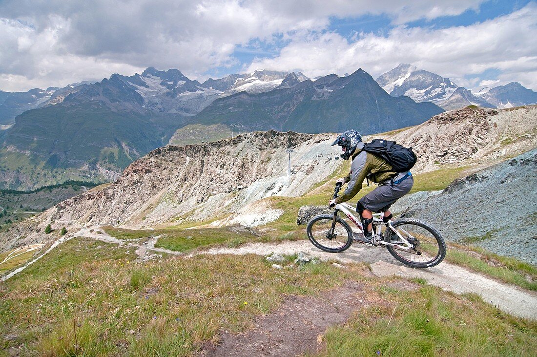 Elijah Weber mountain biking the Murmelweg Trail above Blauherd in the Swiss Alps high above the town of Zermatt Switzerland