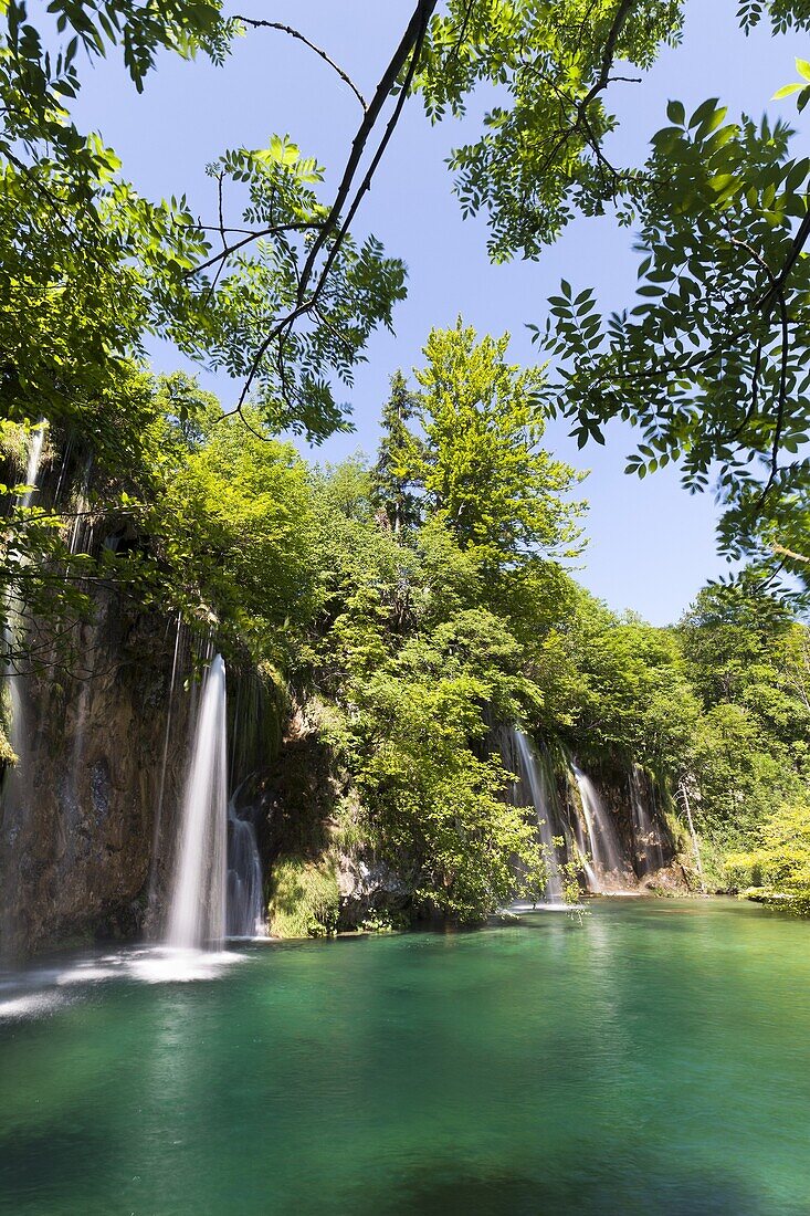 The Plitvice Lakes in the National Park Plitvicka Jezera in Croatia The upper lakes, ponds and waterfalls with lush vegetation The Plitvice Lakes are a string of lakes connected by waterfalls They are in a valley, which becomes a canyon in the lower pa