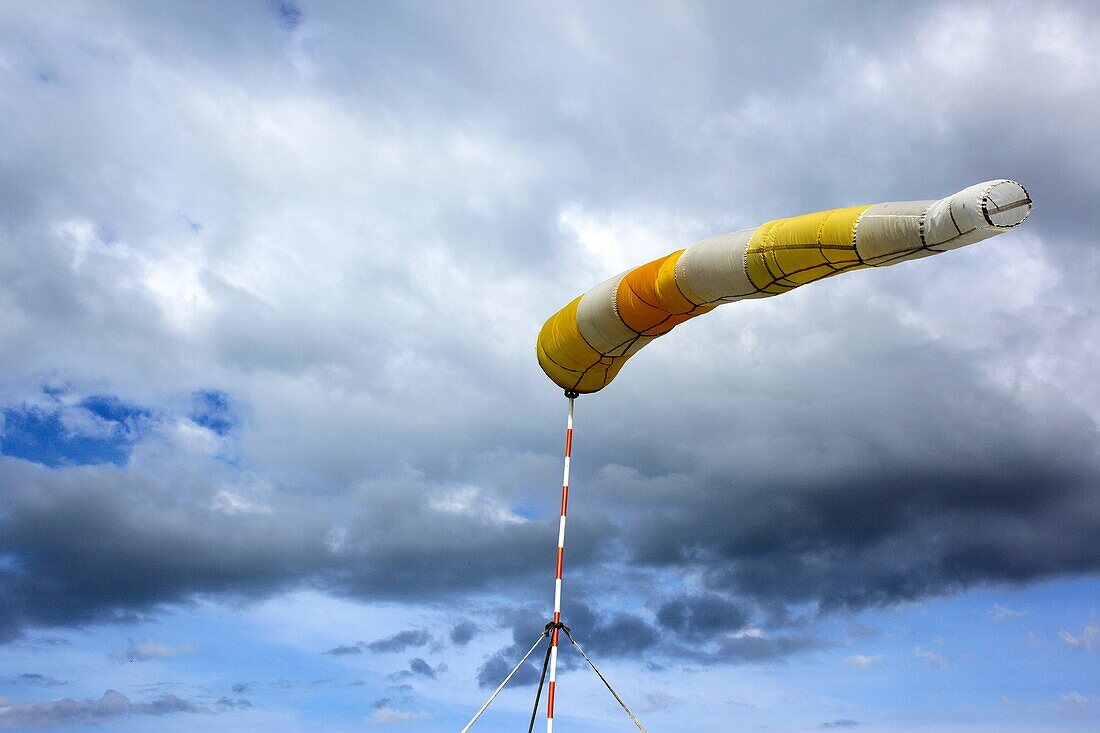 Airport windsock blowing in the breeze with a sky background
