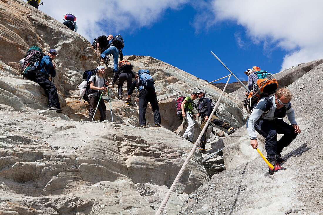 Group of hikers on Gorner glacier, hiking route to Monte-Rosa-Hut, Zermatt, Canton of Valais, Switzerland, myclimate audio trail