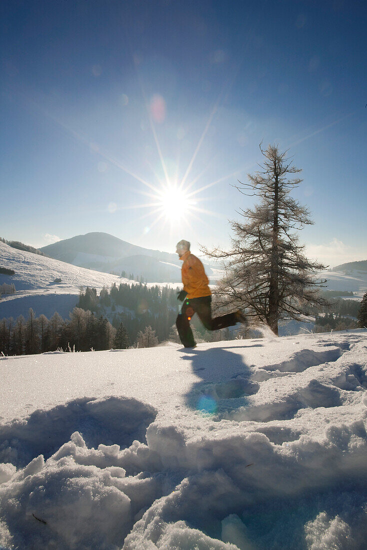 Man jogging on snow, Styria, Austria