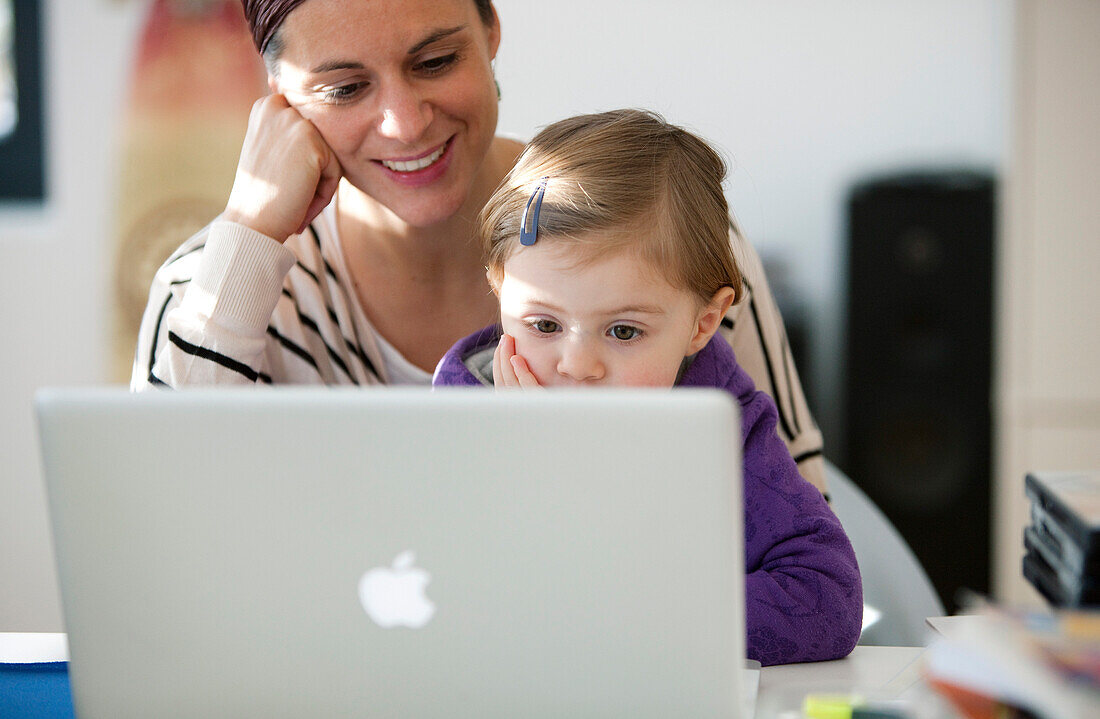 Mother and daughter (2 years) using a laptop