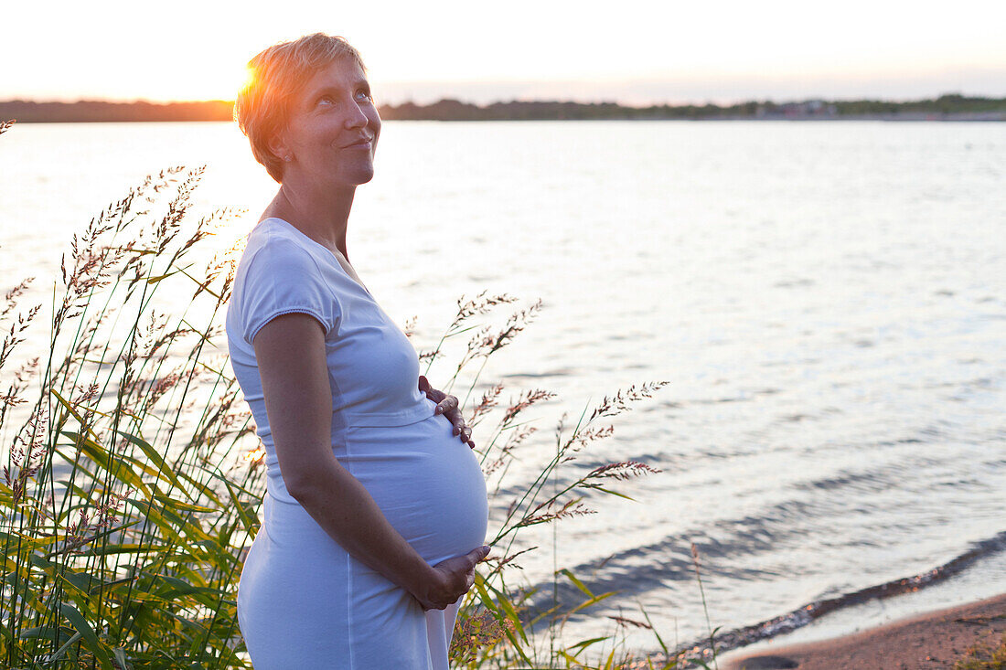Pregnant woman near Cospuden Lake, Leipzig, Saxony, Germany