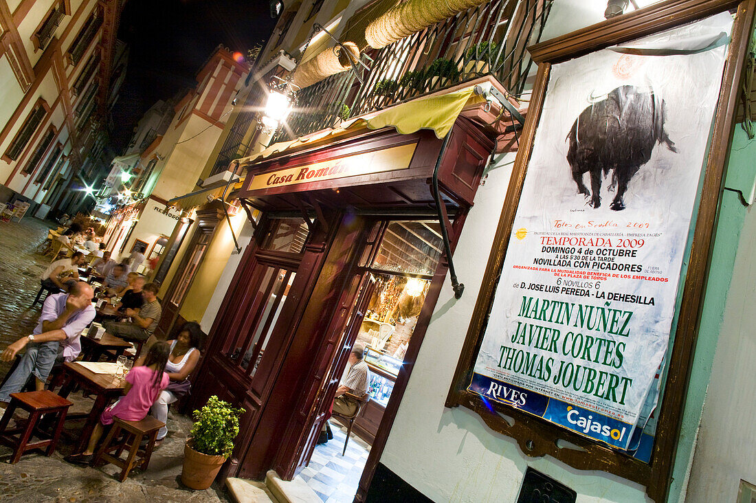 People sat outside a restaurant in the evening, Plaza Venerables, Barrio Santa Cruz, Seville, Spain