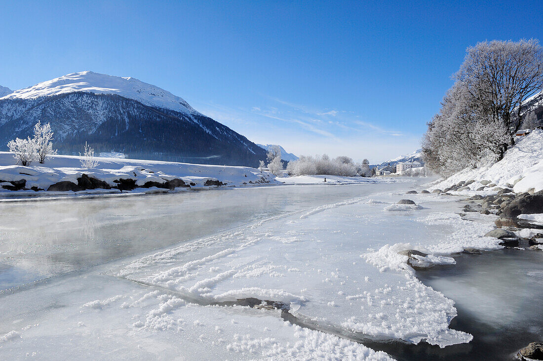 River Inn with ice-covered bank and La Punt-Chamues-ch in background, La Punt, Upper Engadin, Engadin, Grisons, Switzerland, Europe