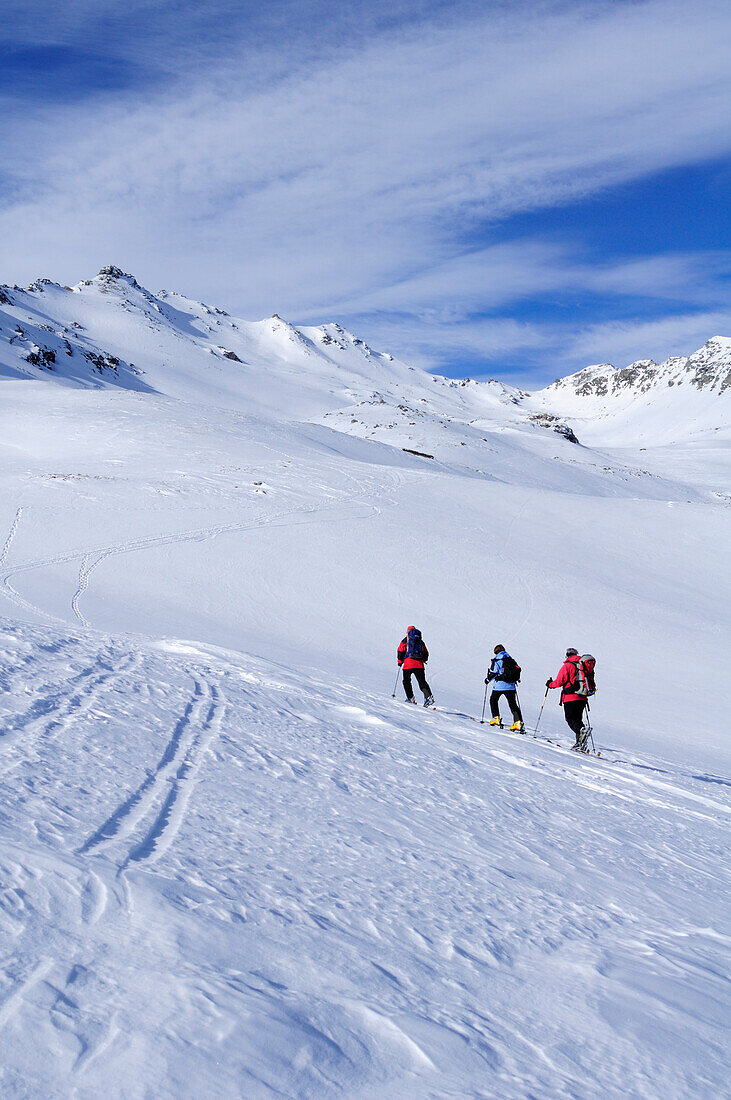 Three persons backcountry skiing ascending towards Piz Scalotta, Piz Scalotta, Bivio, Albula range, Grisons, Switzerland, Europe