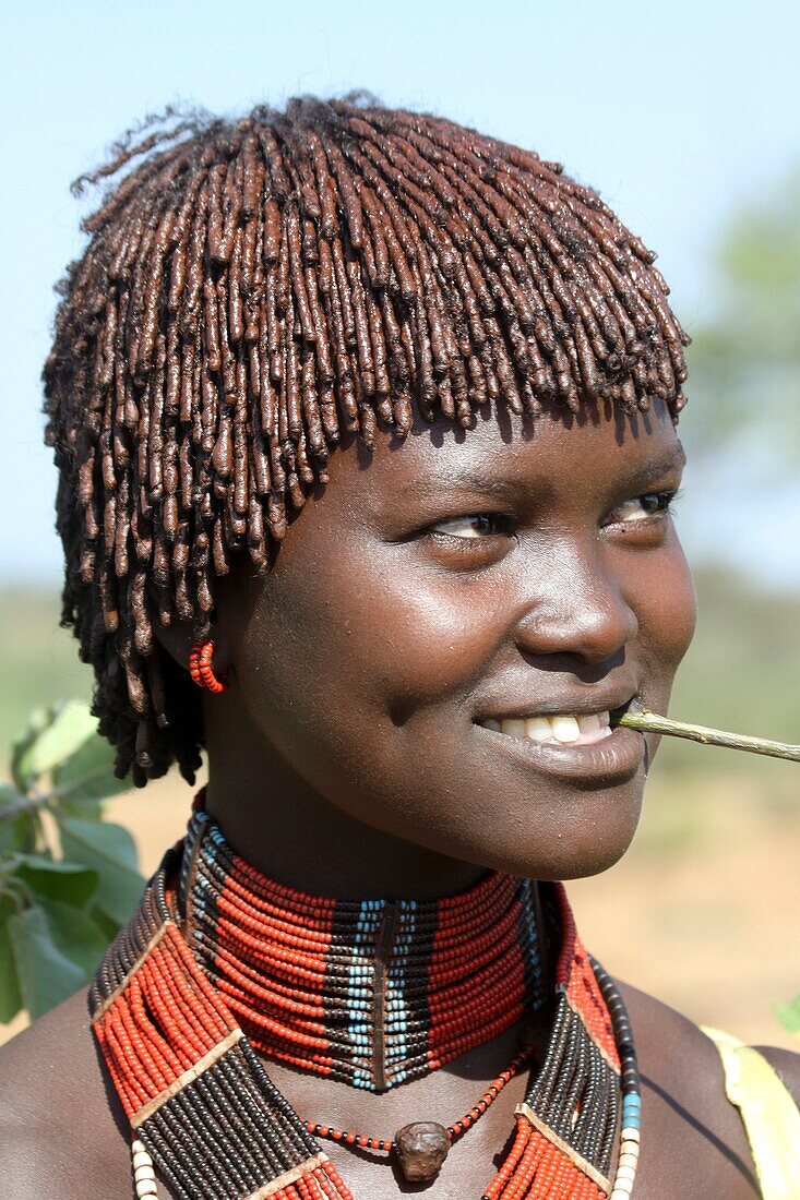 Africa, Ethiopia, Omo River Valley, young Woman of the Hamer Tribe The hair is coated with ochre mud and animal fat
