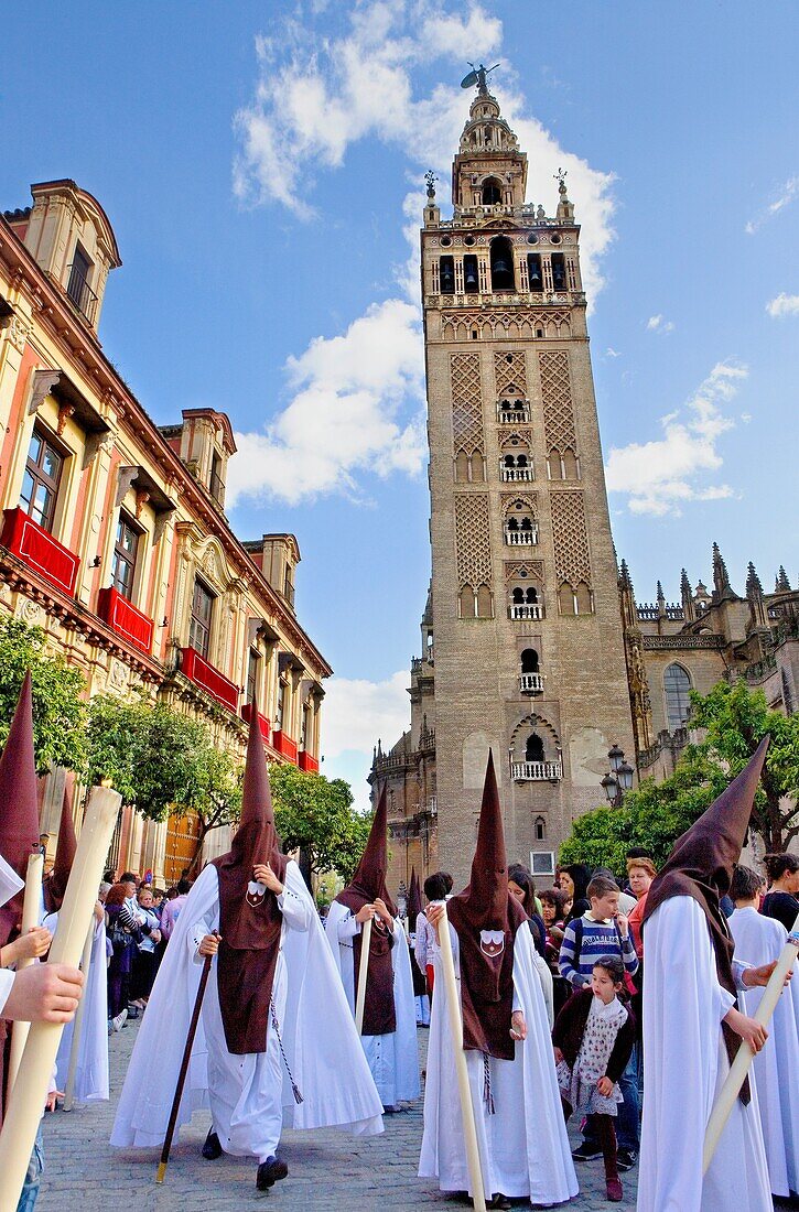Penitents and Giralda Holy Week procession ,  El Carmen Doloroso,  Holy Wednesday Seville Spain