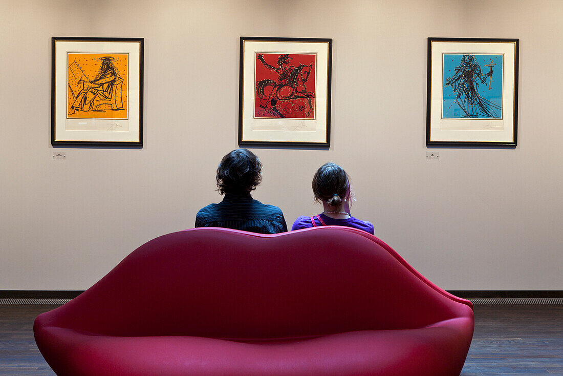 Young couple in the Salvador Dali Museum, Leipziger Platz, Berlin, Germany