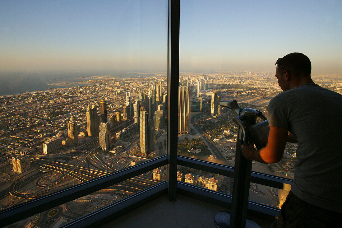 Man enjoying the view from the Observation Deck, At The Top, Burj Khalifa, Burj Chalifa, Sheikh Zayed Road, Dubai, United Arab Emirates, UAE