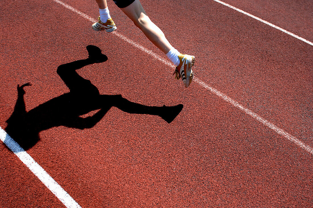 Airborne runner on track with shadow, Running, Leisure & Activities