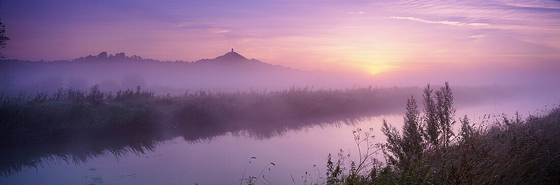 Glastonbury Tor and the Somerset Levels at dawn, Glastonbury, Somerset, UK - England