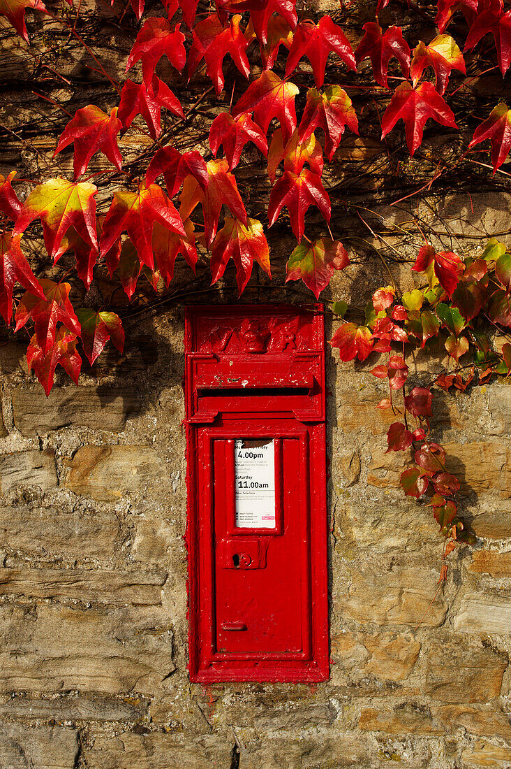 Red post box in wall, Thwaite, Yorkshire, UK - England