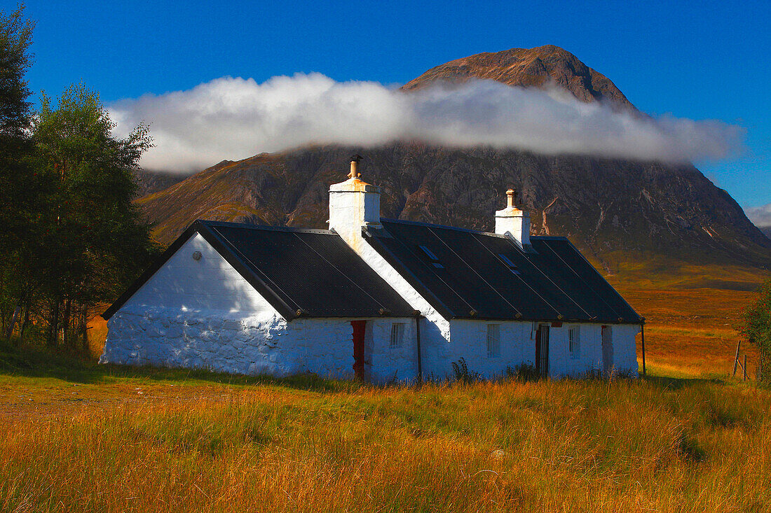 Blackrock cottage with buchaille etive moe in distance, Rannoch Moor, Highland, UK - Scotland