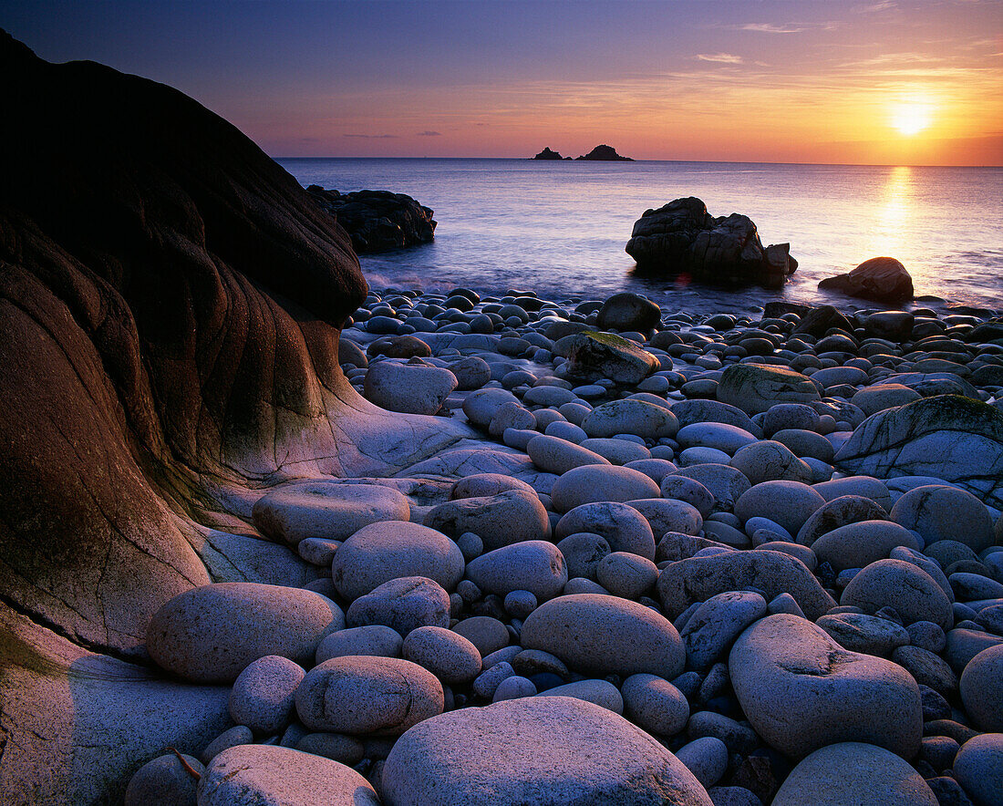 Beach and view to The Brisons rocks at sunset, Porth Nanven, Cornwall, UK - England