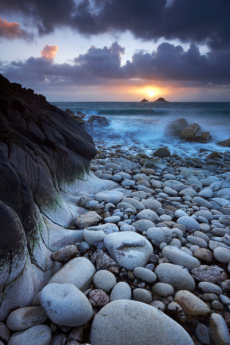 Rocky beach at sunset, Porth Nanven, Cornwall, UK - England
