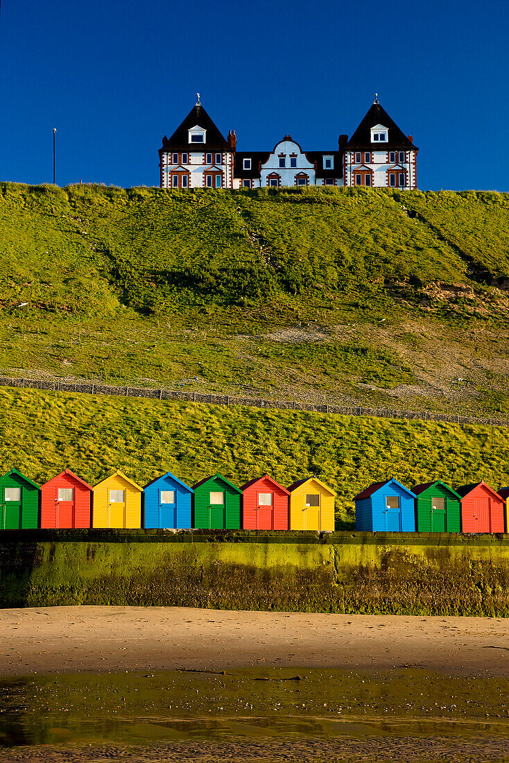 Colourful beach huts on North Beach, Whitby, Yorkshire, UK - England