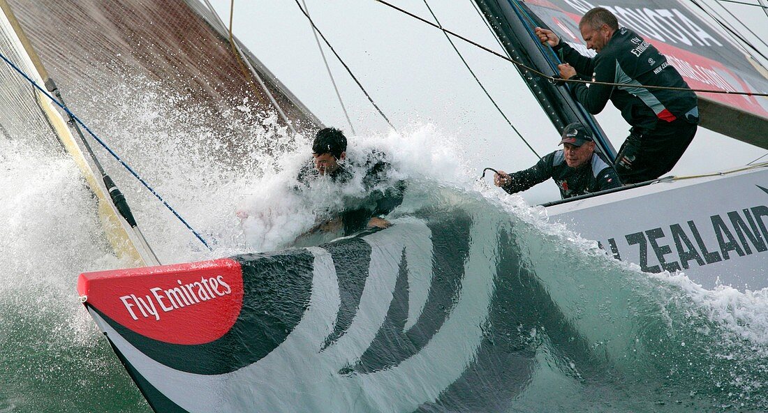 Crew members of America's Cup challenger Emirates Team New Zealand work on the bow while they rounds the windward mark at the Louis Vuitton Cup in Valencia