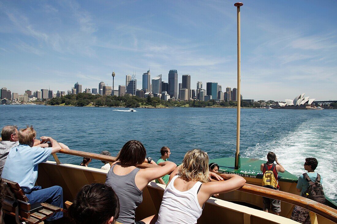 tourists on the Manly Ferry watching the Skyline and Opera in Sydney, New South Wales, Australia