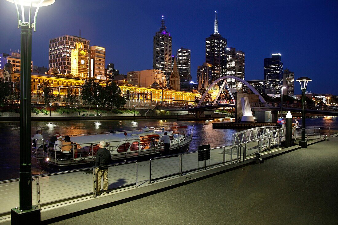 Boat embarking from Southbank and the Melbourne Skyline at night, Victoria, Australia
