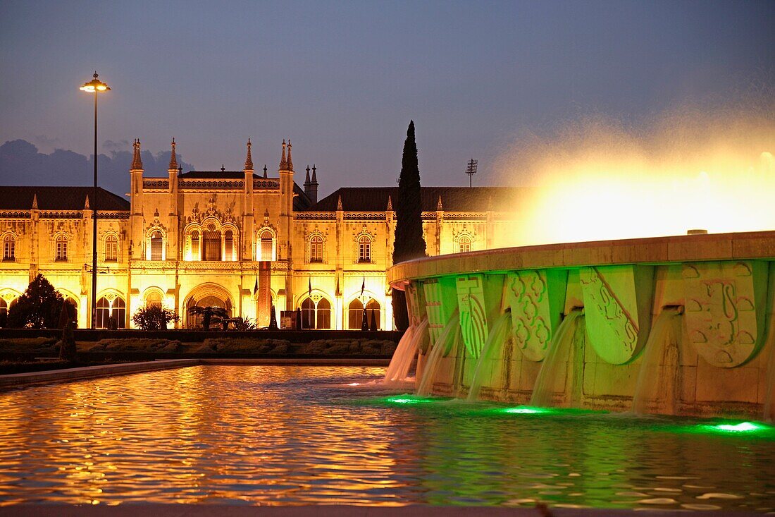 illuminated fountain and Jeronimos Monastery Mosteiro dos Jerominos in Belem, Lisbon, Portugal, Europe