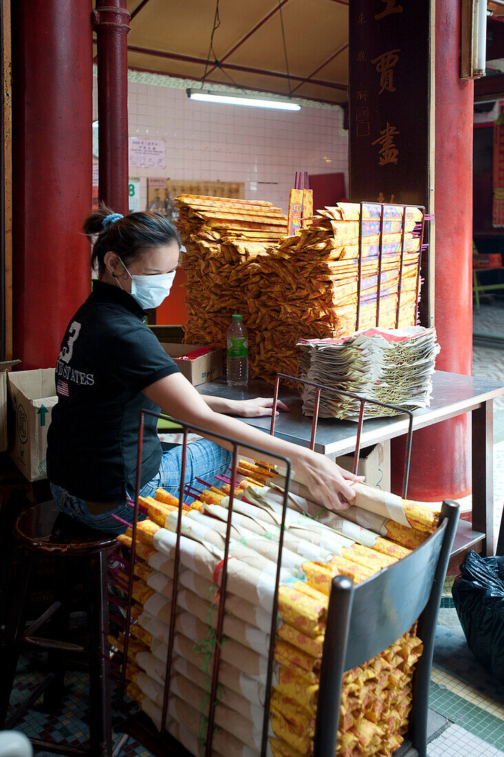 Young woman working in a Chinese Temple, Kuala Lumpur, Malaysia, Asia