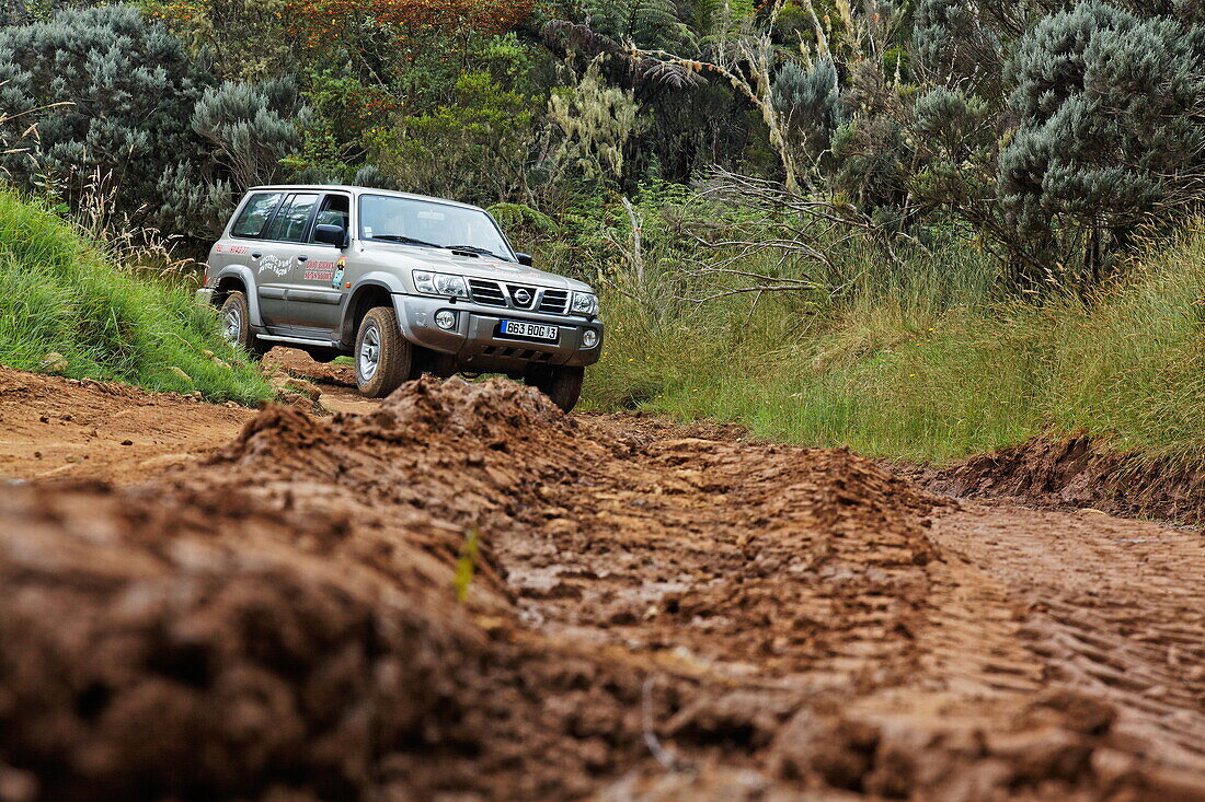 Off-road vehicle on muddy road, Tour to Dimitile mountain, La Reunion, Indian Ocean