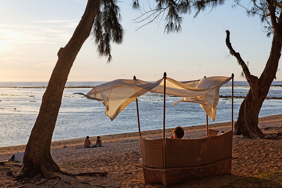 Beach chair on the beach of Grand Hotel du Lagoon at sunset, Saint Gilles, La Reunion, Indian Ocean