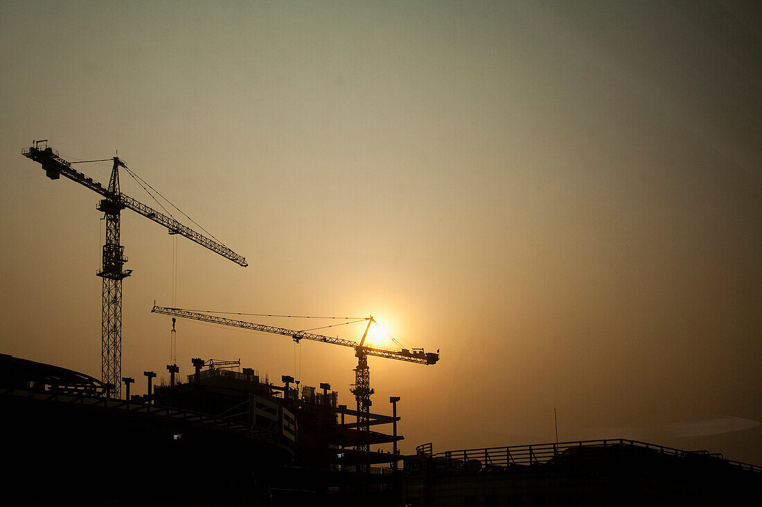 Silhouetted Construction Cranes, Beijing, China