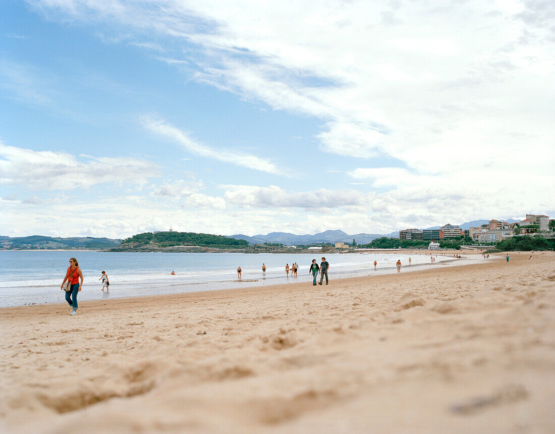 People walking along the beach at Playa Sardinero, Santander, Cantabria, Spain