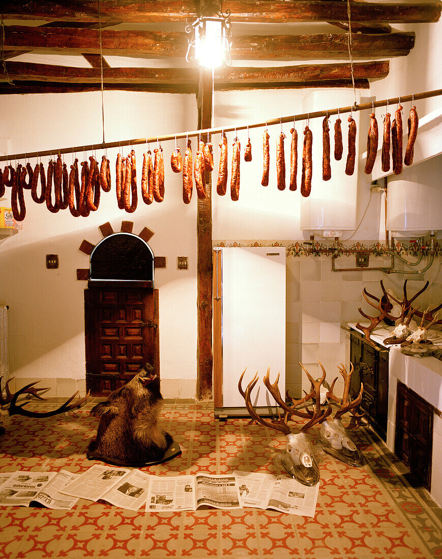 Sausages hung up to dry and hunting trophies, finca Arzuaga, near Quintanilla, Castile and León, Spain