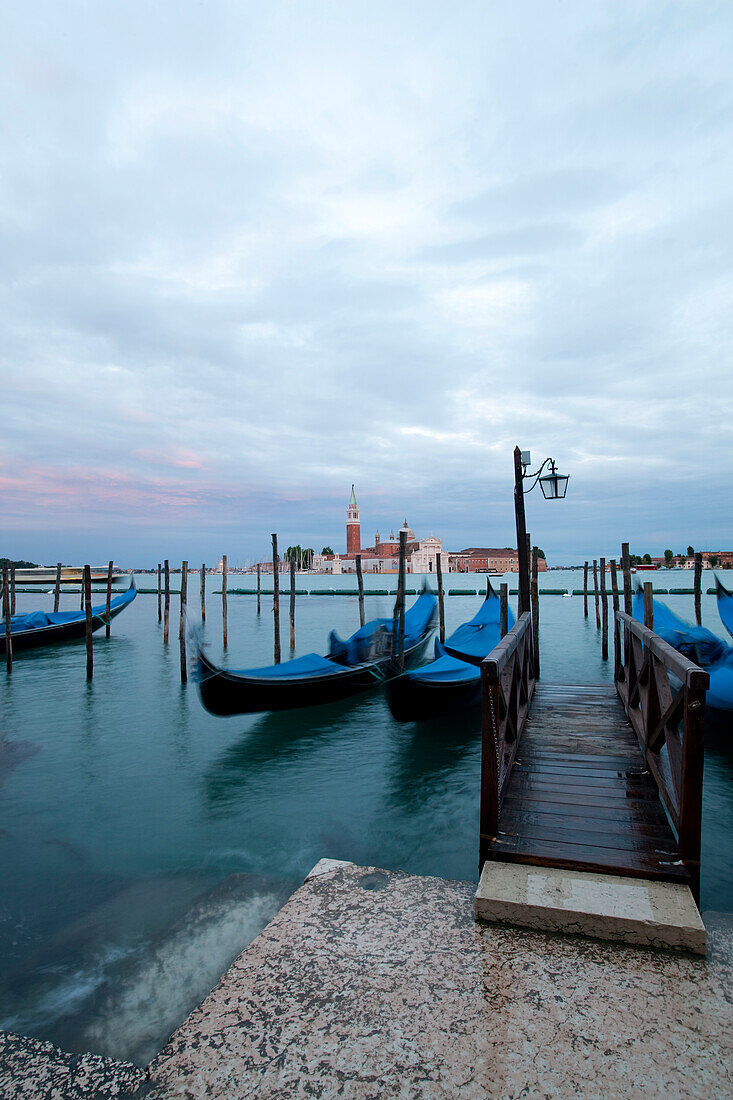 Gondolas moored at a jetty, Venice, Italien