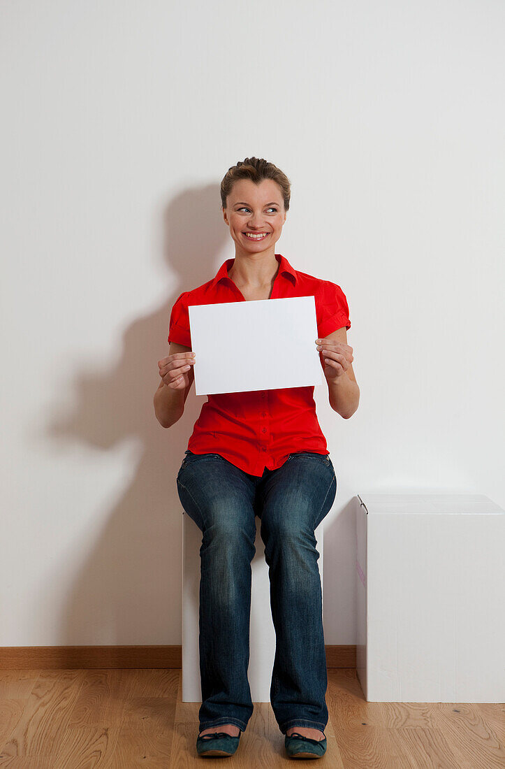 Young woman holding a piece of paper