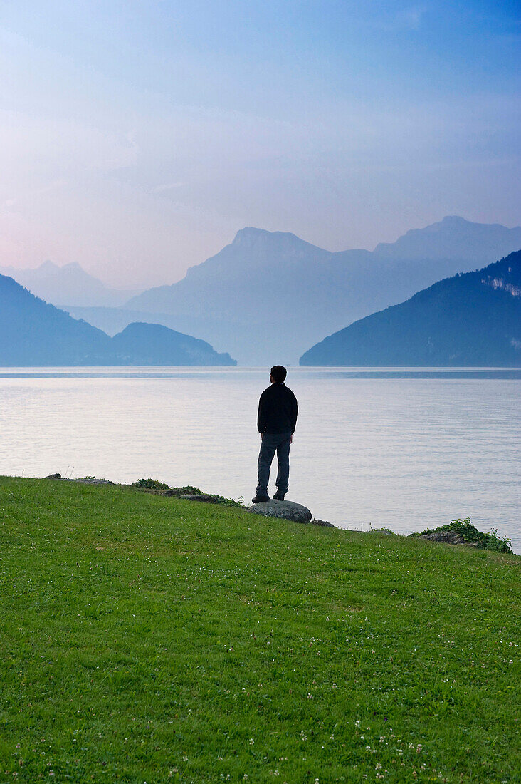 Mann looking over Lake Lucerne in the morning, Weggis, Canton of Lucerne, Switzerland