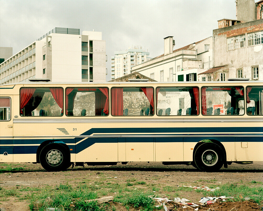 Bus in front of newly built Casino Hotel and old houses at the harbour in Ponta Delgada, Sao Miguel island, Azores, Portugal