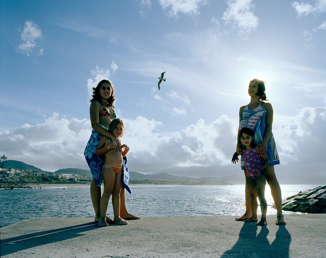 Women with kids at the marine pool in Ribeira Grande, northern shore of Sao Miguel island, Azores, Portugal