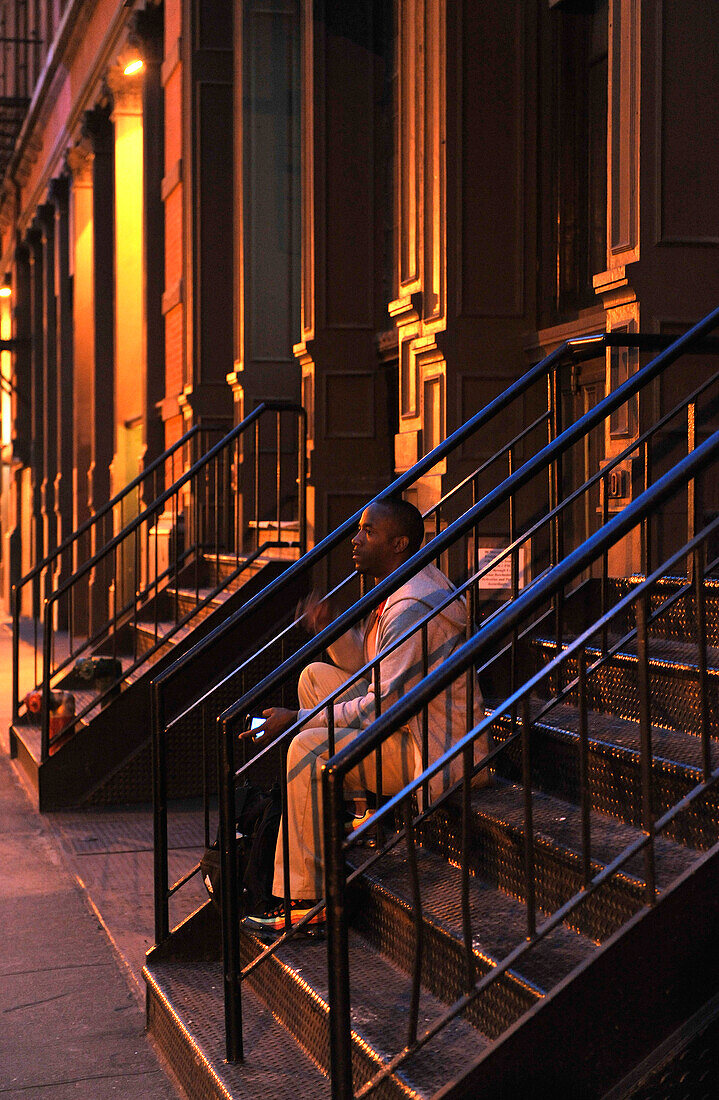 One man sitting on a staircase, Soho, Manhattan, New York City, New York, USA, North America, America