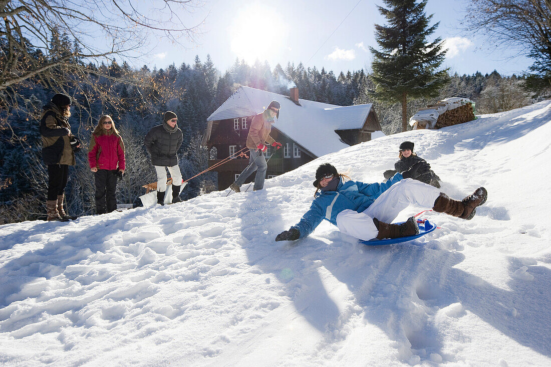 Children playing in snow, St Peter, Black Forest, Baden-Wurttemberg, Germany