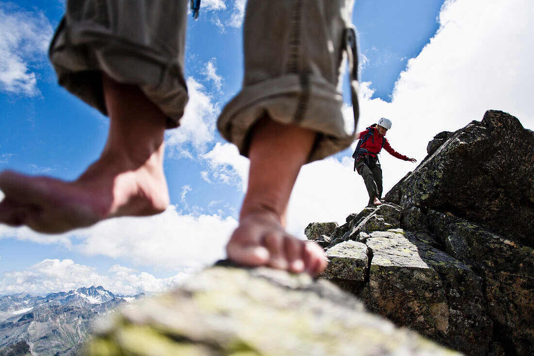 Two barefoot women on summit of mount Grosslitzner, Silvretta mountain range, Vorarlberg, Austria