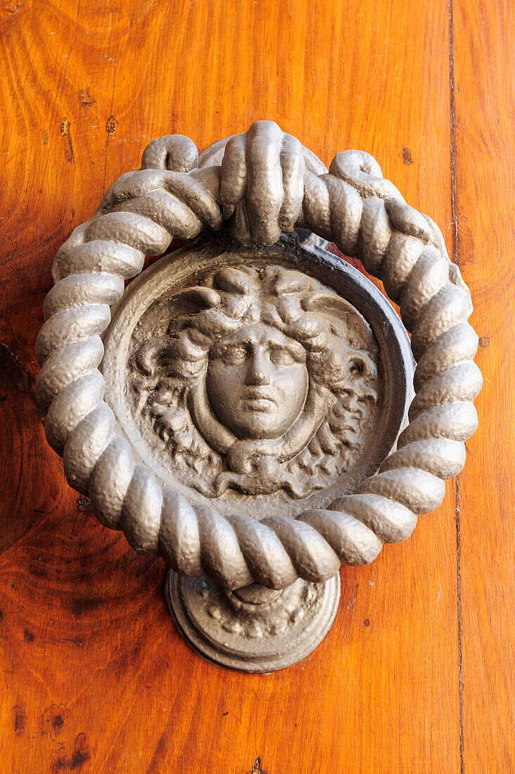 Door knocker in the shape of a face, Montepulciano, Tuscany, Italy