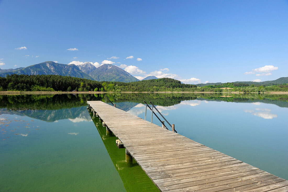 Wooden landing stage leading into lake Turnersee, Karawanken range in the background, lake Turnersee, Carinthia, Austria, Europe