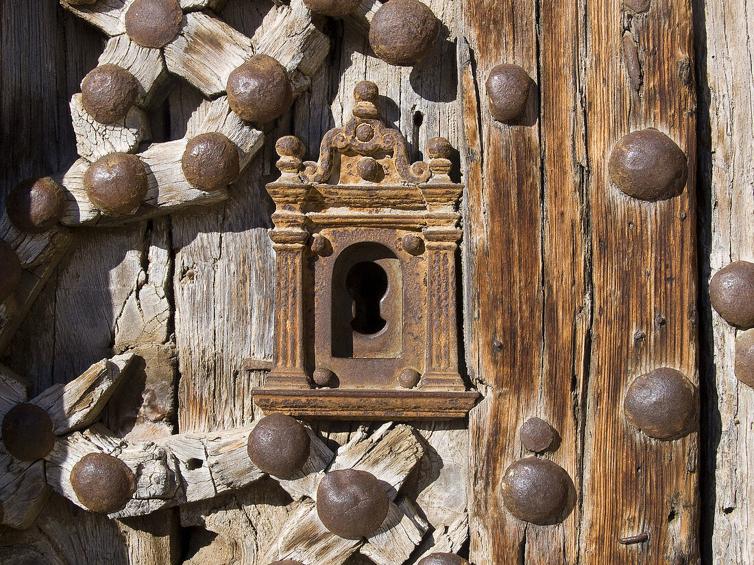 Detail of weathered wooden door, Door of the Apostles (14th century) of the church of Santa Maria la Mayor, Morella. Els Ports, Castellon province, Comunidad Valenciana, Spain