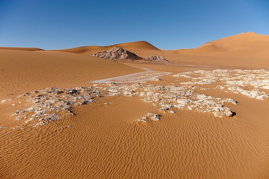 Salt concretions, dunes and Akakus massif near Ghat, Wadi Tanezzouft, Ghat, Libia