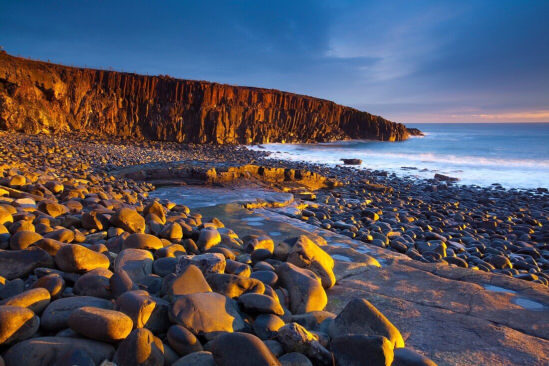 England, Northumberland, Cullernose Point Dawn light illuminates the rocky shoreline of Cullernose Point, near the village of Craster on the Northumberland Heritage Coast
