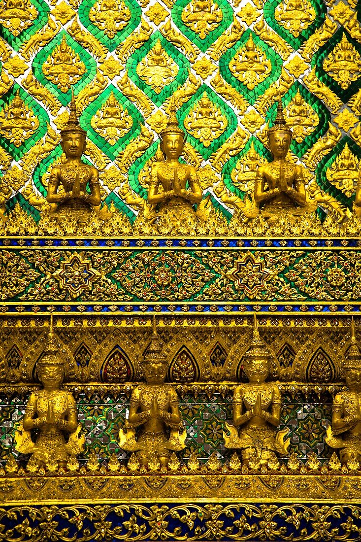 Thailand, Bangkok, The Grand Palace Statue in the ornate setting of the golden grand palace