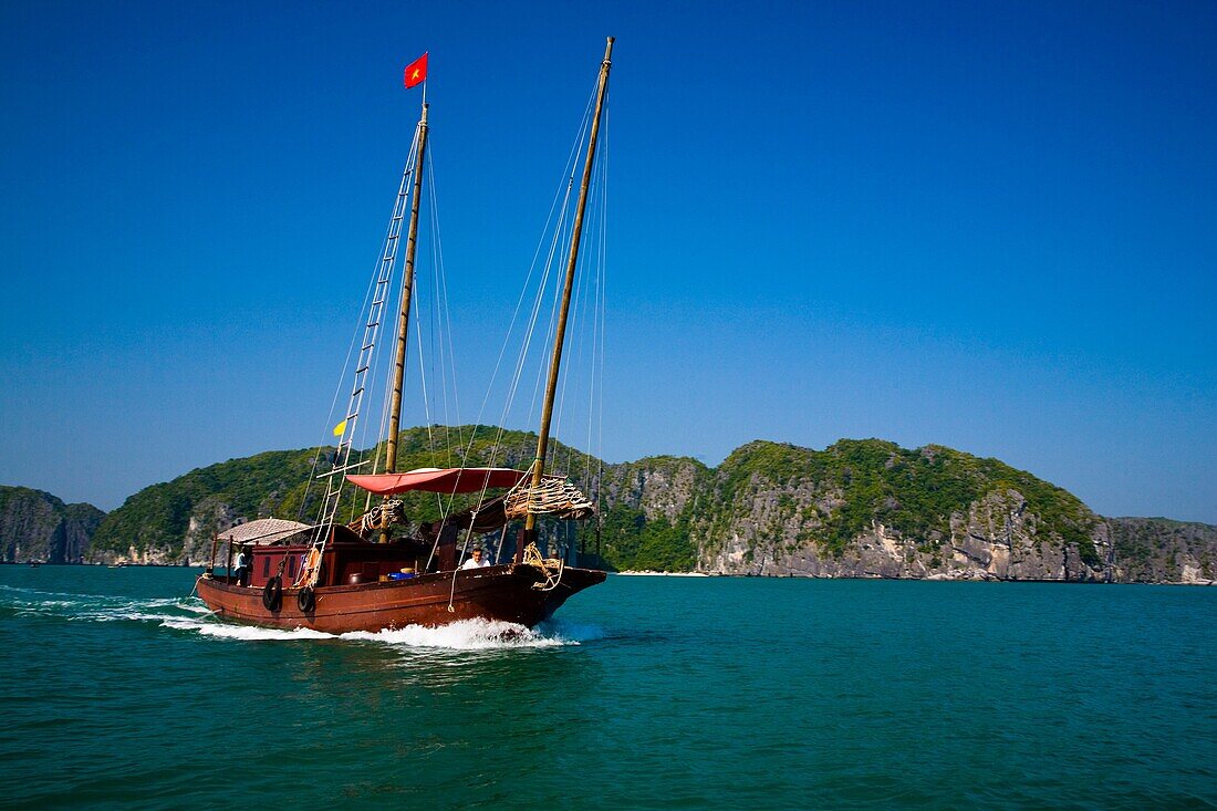 Vietnam, Northern Vietnam, Halong Bay Tourist boat amid the islands of Halong Bay near Cat Ba Island