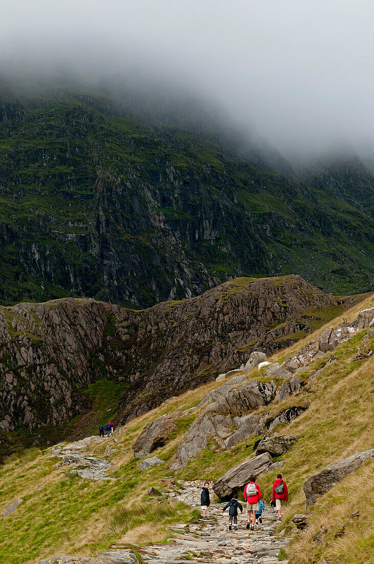 Family walking the Miners Track towards Mt. Snowdon, Snowdonia National Park, Wales, UK