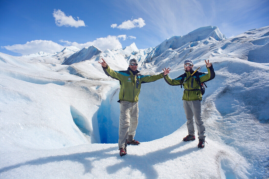 Tour guides in front of an ice cave, ice trekking, Perito Moreno glacier, Lago Argentino, Los Glaciares National Park, near El Calafate, Patagonia, Argentina